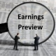 Magnifying glass focused on earnings preview